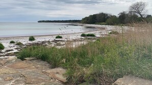 A coastal landscape with a stone pathway leading to a sandy beach. - "Hildegunda" - 280m from the sea by Interhome (Nexø)
