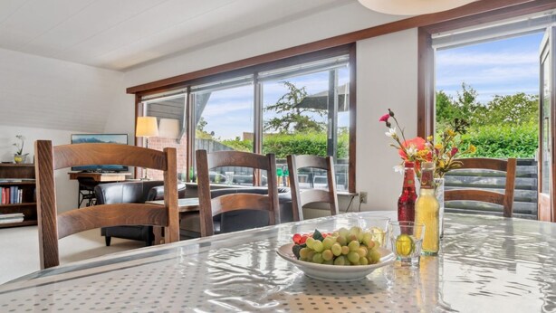 A dining area with a glass table, chairs, and a bowl of fruit. - "Hildegunda" - 280m from the sea by Interhome (Nexø)
