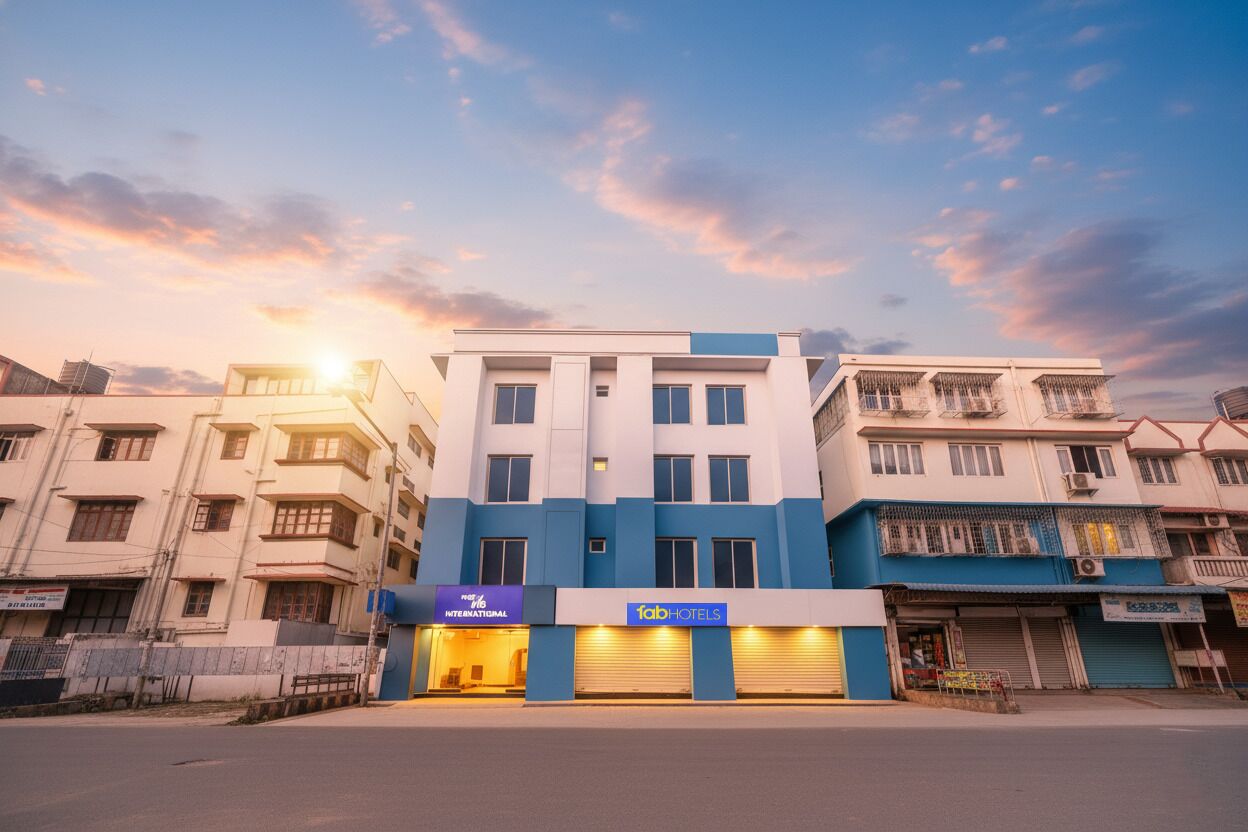 A hotel with a blue and white facade, multiple floors, and a sign for 'fabHOTELS'.