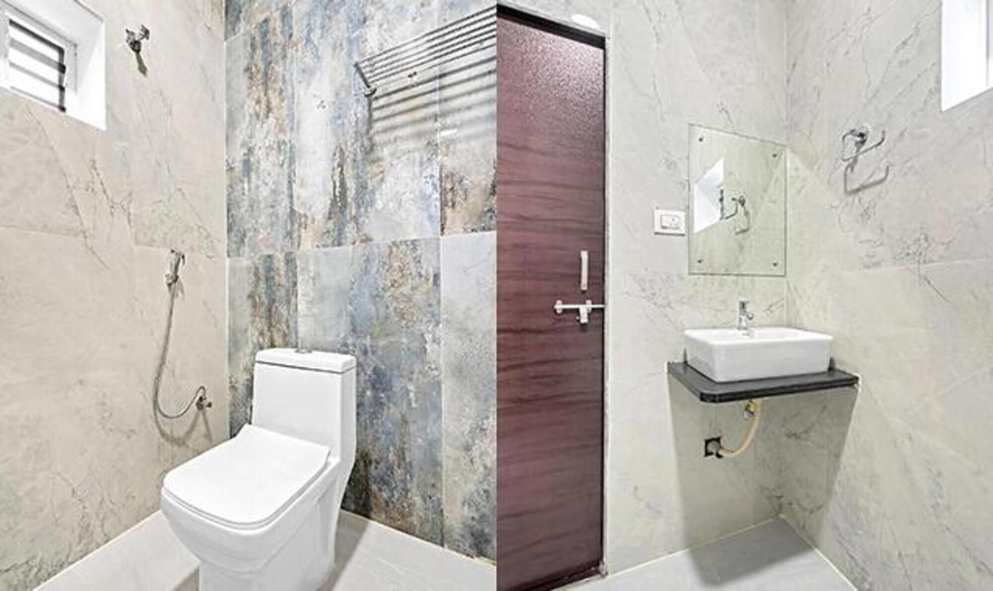 A bathroom with a toilet, shower, and sink.