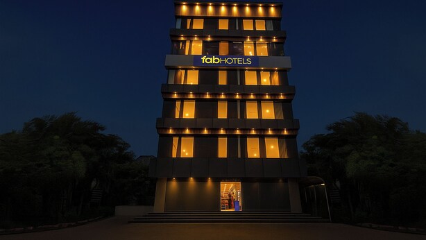A modern hotel building with a prominent 'fabHOTELS' sign, multiple floors, and illuminated windows. - Fabhotel Yendluri'S Abode (Hyderabad)