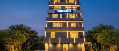 A multi-story hotel with a modern design, featuring a prominent 'fabHOTELS' sign.