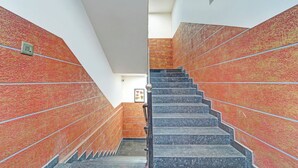 A staircase with red and black tiles, leading to a lower level. - Fabhotel Pk Residency (Ernakulam)