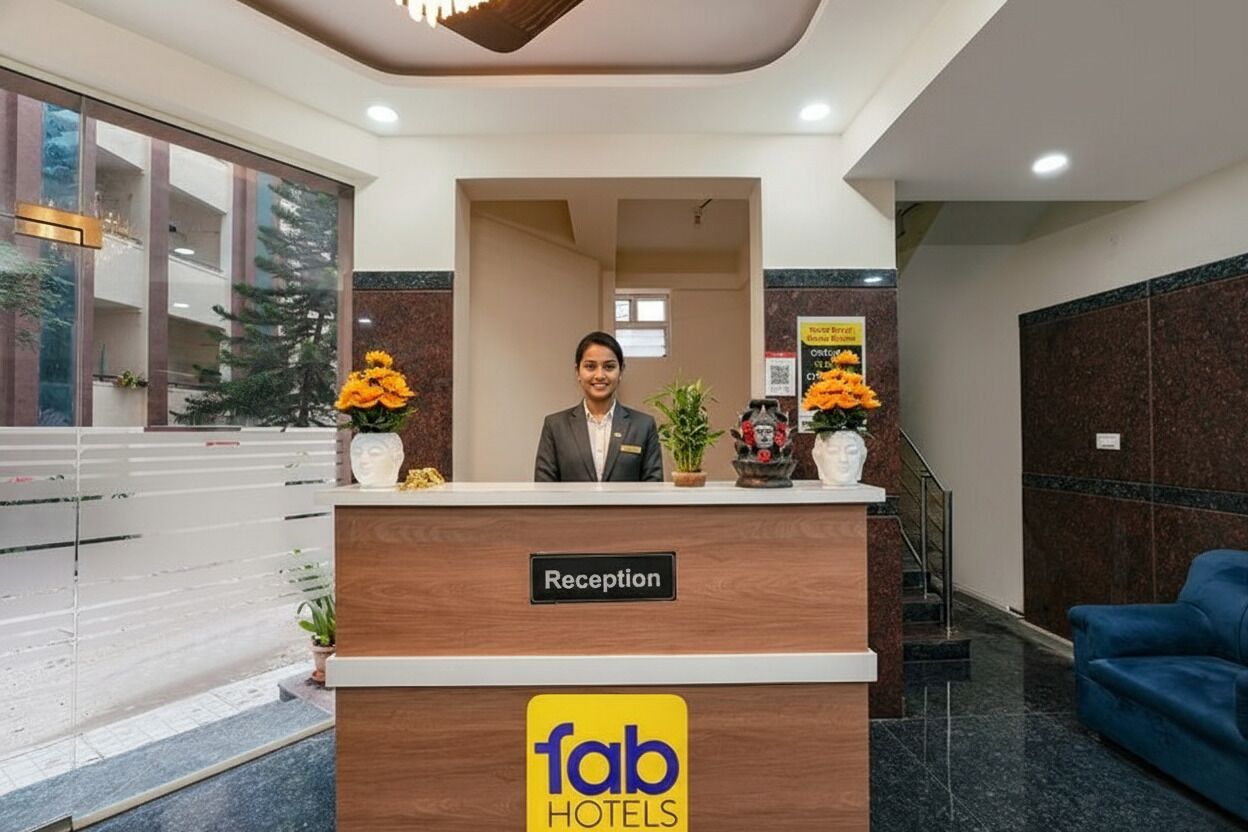 A reception desk with a sign reading "Reception" and the logo "fab hotels".