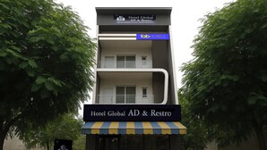 A multi-story hotel building with a sign for 'Hotel Global AD & Restro'. - Fabhotel Global Ad (Indore)