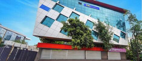 A modern building with a 'fab hotel' sign, large windows, and a red and white facade.