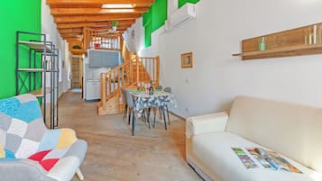 Family Apartment, Multiple Bedrooms (Nido dell'Usignolo) | Living area | 21-inch Smart TV with cable channels