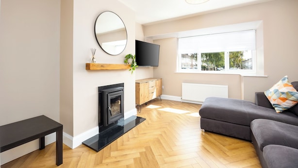 A modern living room with a fireplace, a television, and a large window. - 3 Bed Home W/Garden By Phoenix Park & Dublin Zoo (Sublin 7)