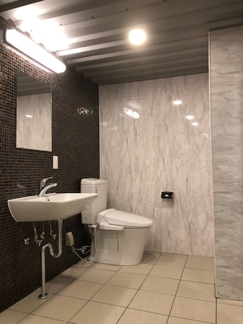 Combined shower/bathtub, slippers, towels, soap. Hotel Bali Beach
