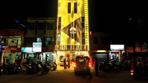 A building with a prominent yellow facade and a visible entrance. - Hotel BS International Mysore (Mysore)