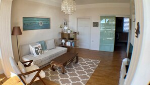 A living room with a sofa, coffee table, and decorative items.