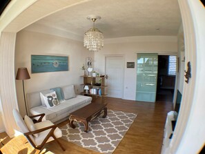 A living room with a sofa, coffee table, and decorative items.