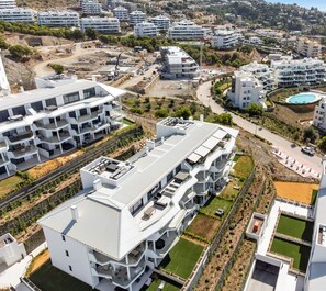 A modern residential complex with multiple buildings, featuring balconies, a swimming pool, and landscaped gardens. - Mimosa | Sea views - terrace (Fuengirola)