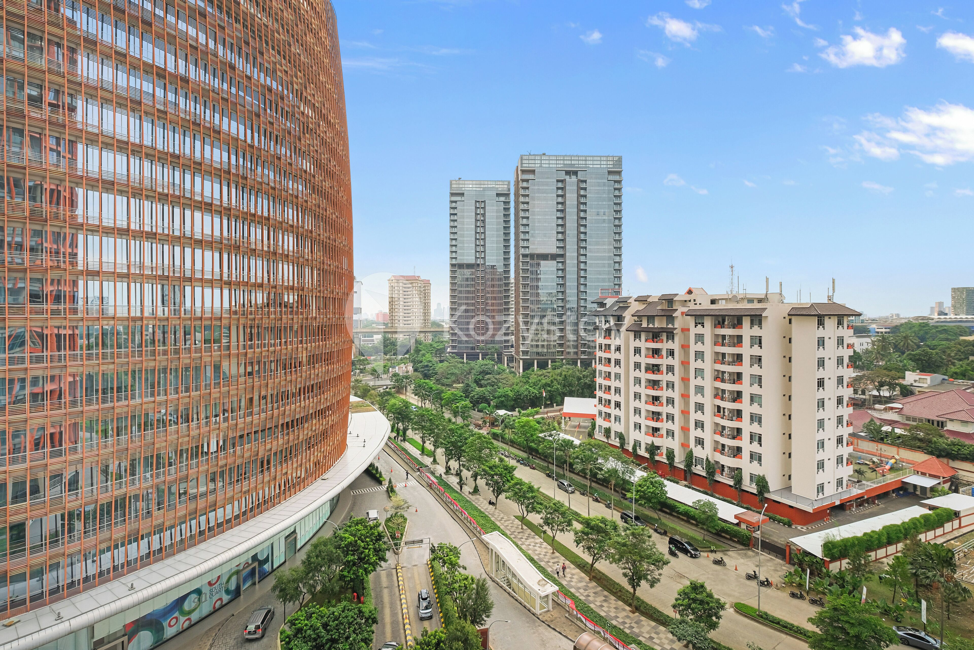 A modern urban area with high-rise buildings, a curved structure with a grid pattern, and a well-maintained road with greenery.