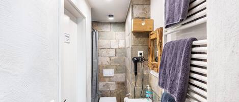 A bathroom with a toilet, sink, and towel rack.