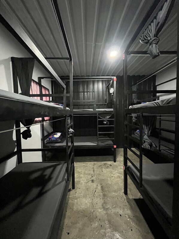 A bunk bed room with a concrete floor and metal railings. - SongKler (Ko Pha-ngan)