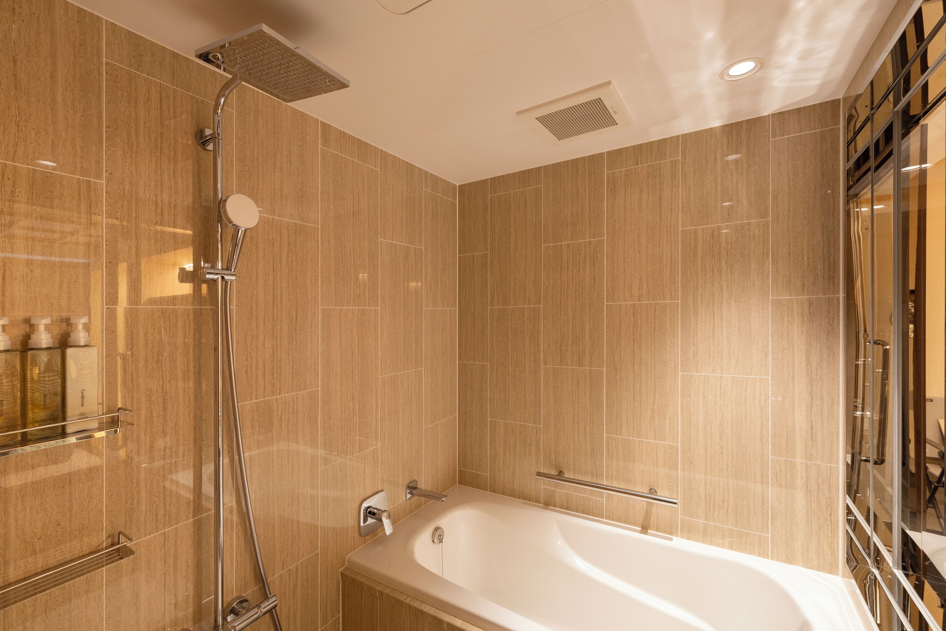 A modern bathroom with a freestanding bathtub, a showerhead, and a glass shower enclosure.