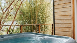 A hot tub on an outdoor deck with bamboo trees in the background. - Chalet with Jacuzzi and Terrace in Bormes-les-Mimosas (Bormes-les-Mimosas)