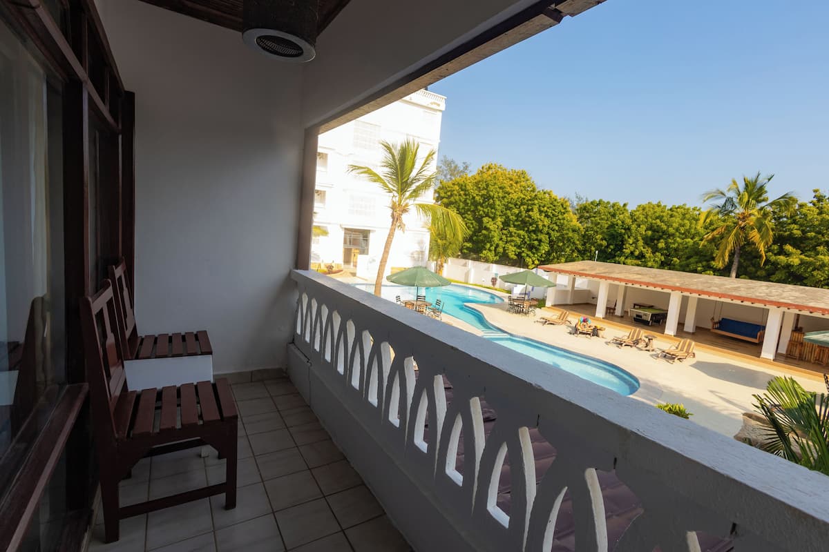 Standard Double Room, Balcony, Pool View | In-room safe, desk, laptop workspace, blackout drapes