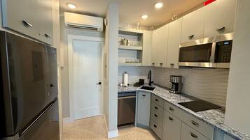 Fridge, microwave, coffee/tea maker, cookware/dishes/utensils