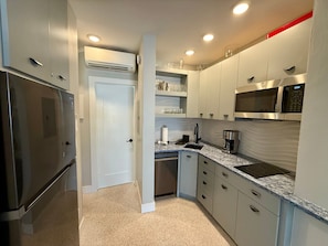 Fridge, microwave, coffee/tea maker, cookware/dishes/utensils