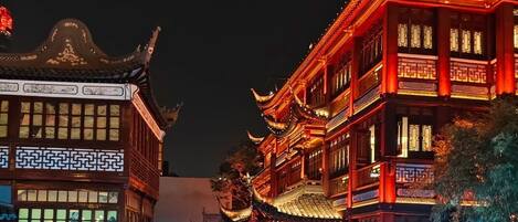 A traditional Chinese building with ornate architecture and a water feature in front.