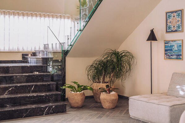 A staircase with marble steps, a glass railing, and potted plants. - Hotel Ben Marsalforn, Affiliated By Meliá (Zebbug)
