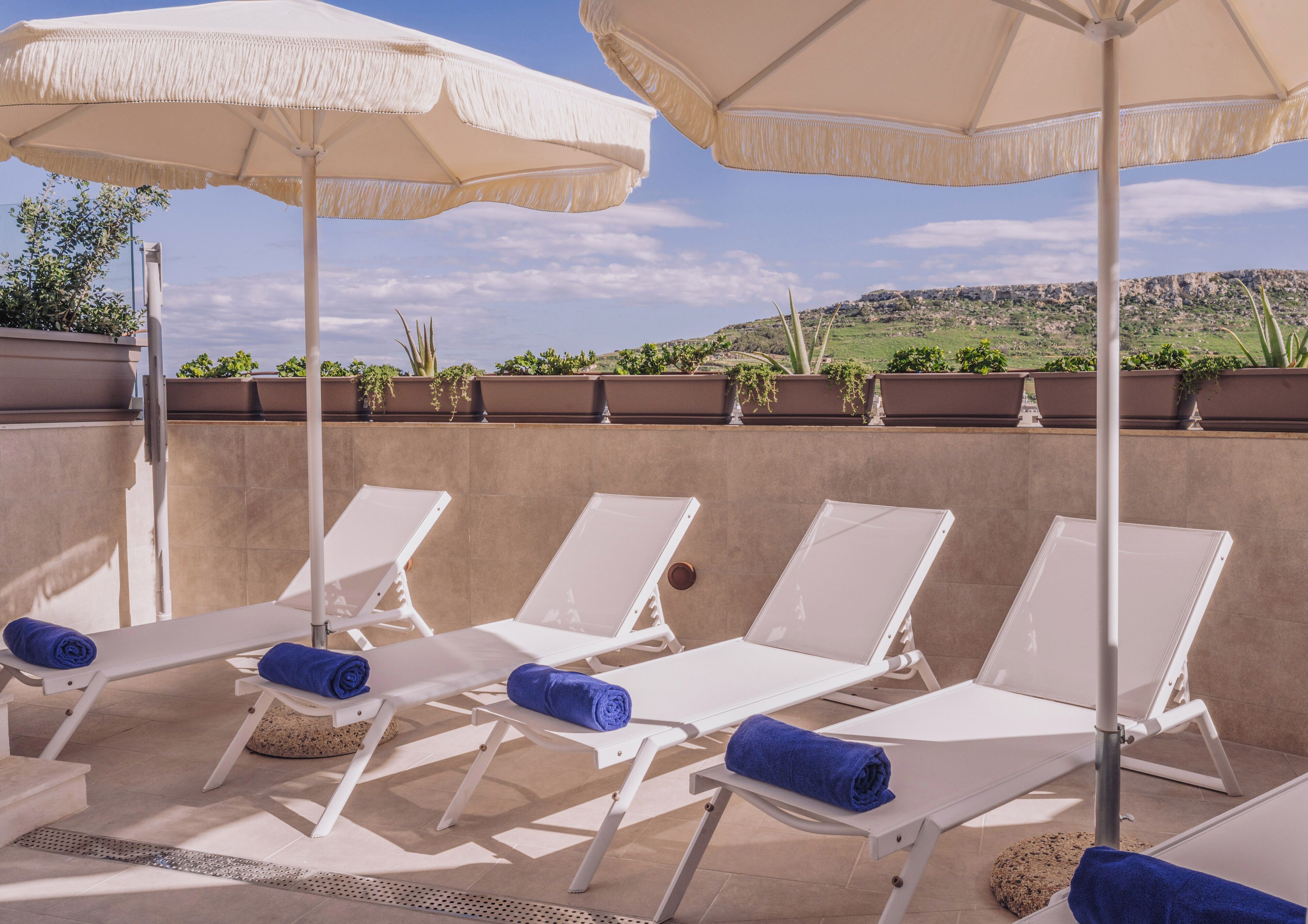 Indoor pool, outdoor pool, pool umbrellas, pool loungers