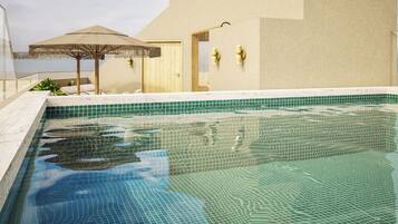 Indoor pool, outdoor pool, pool umbrellas, pool loungers