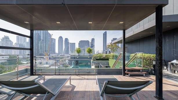 A rooftop terrace with lounge chairs, a small pool, and a city view. - Shine Thonglor (Bangkok)