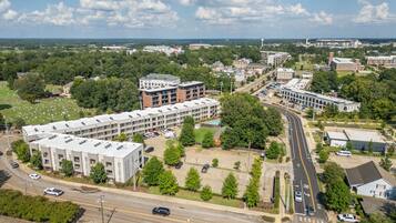 An aerial view of a campus with multiple buildings, roads, and green spaces.