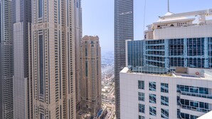A high-rise building with a modern architectural design, featuring multiple floors and a prominent glass facade. - Spacious 3-bedroom With Comfortable Living Area in Dubai Marina (Dubai)
