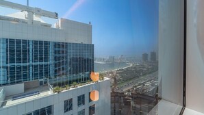 A modern building with large windows and a view of a coastal cityscape. - Spacious 3-bedroom With Comfortable Living Area in Dubai Marina (Dubai)
