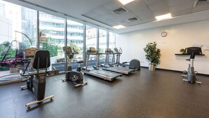 A gym with treadmills, stationary bikes, and a rowing machine. - 1608 Siverene Tower A (Dubai)