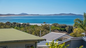 A coastal property with a view of the ocean and distant hills. - We’re thrilled to introduce this stunning new listing with The Lifestyle Group, Crescent Head. (Crescent Head)