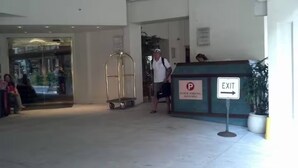 A reception area with a sign indicating public parking and an exit. - Stay steps from the sand in this private studio at the Imperial Resort. Walk to shops, dining & nightlife. Rooftop pool, hot tub, gym, and kitchen included! (Honolulu)
