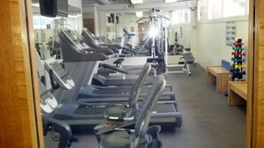 A gym with multiple treadmills, exercise equipment, and a mirror wall. - Stay steps from the sand in this private studio at the Imperial Resort. Walk to shops, dining & nightlife. Rooftop pool, hot tub, gym, and kitchen included! (Honolulu)