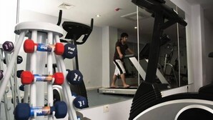 A gym with exercise equipment, including a treadmill and dumbbells. - White Lilyum Hotel- All Inclusive (Kemer)