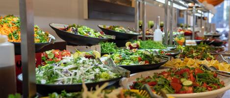 A buffet with various salads and dishes.