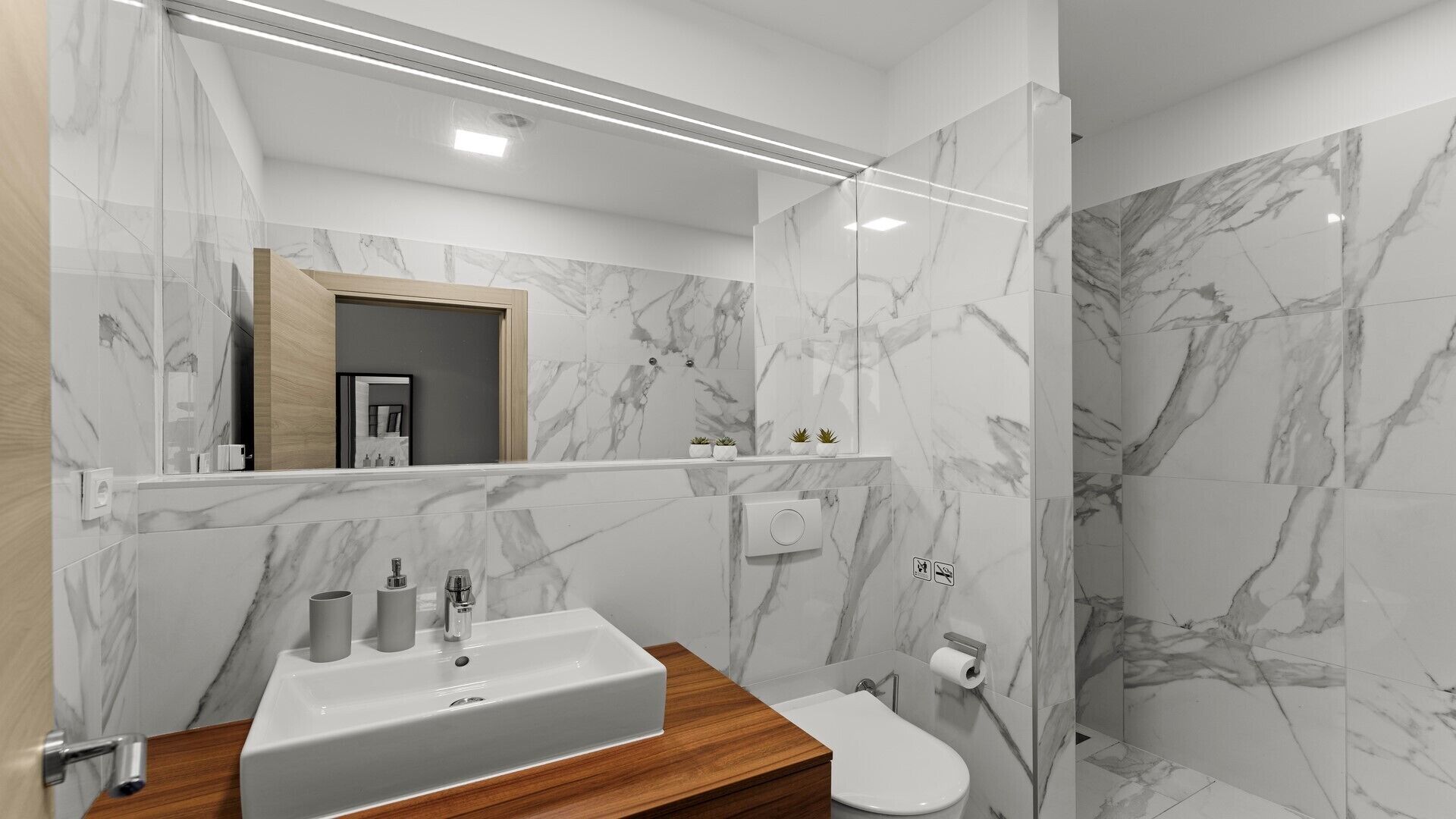 A modern bathroom with a marble backsplash, a wooden vanity, a sink, a toilet, and a shower area.
