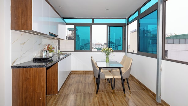 Una cocina moderna con comedor, ventanas amplias y vista a la ciudad.