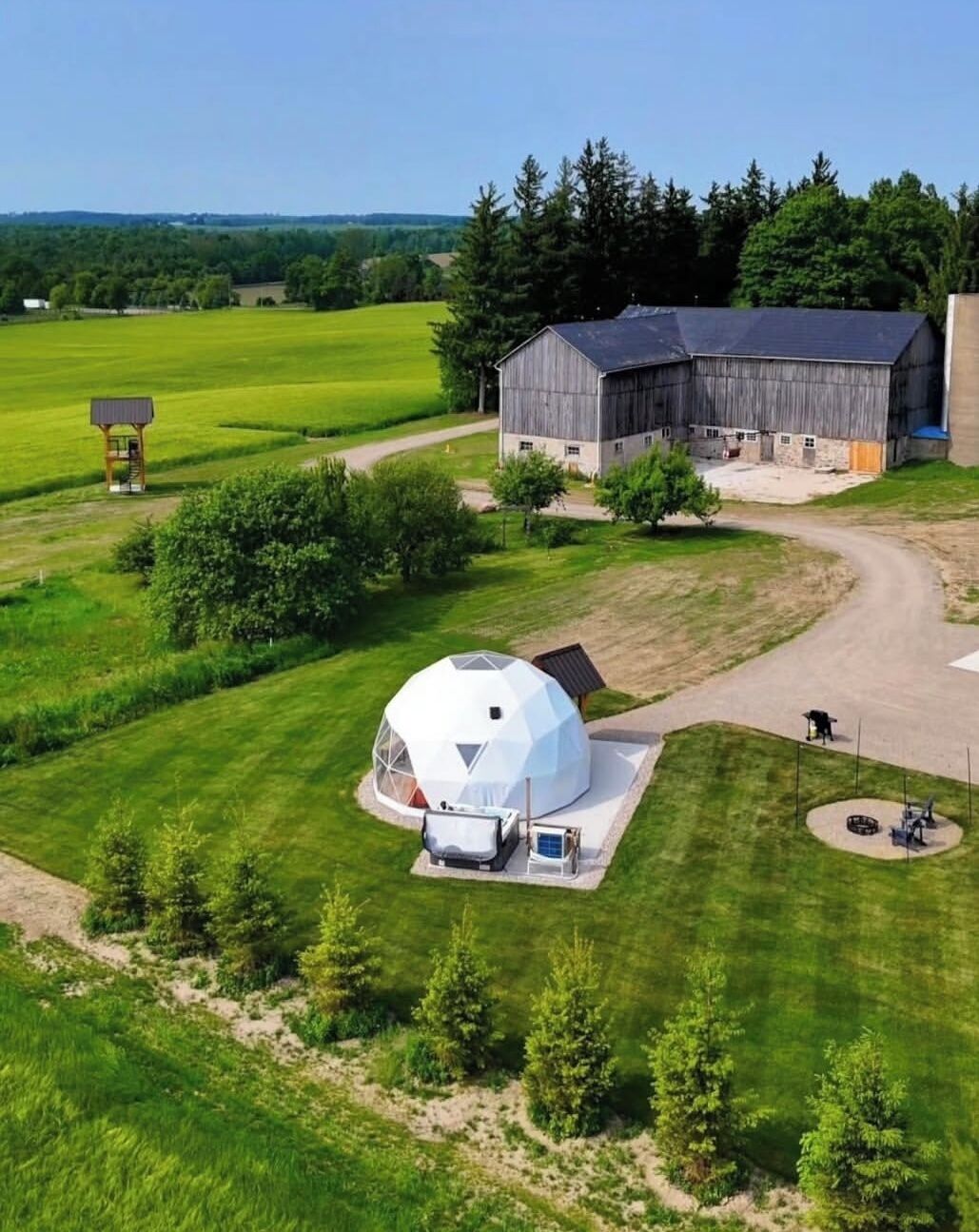 A large barn with a dome structure in a rural setting.