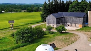 A large barn with a dome structure in a rural setting. - The Sunset Dome- a private escape, with breathtaking sunsets, rooted in nature. (Guelph/Eramosa)