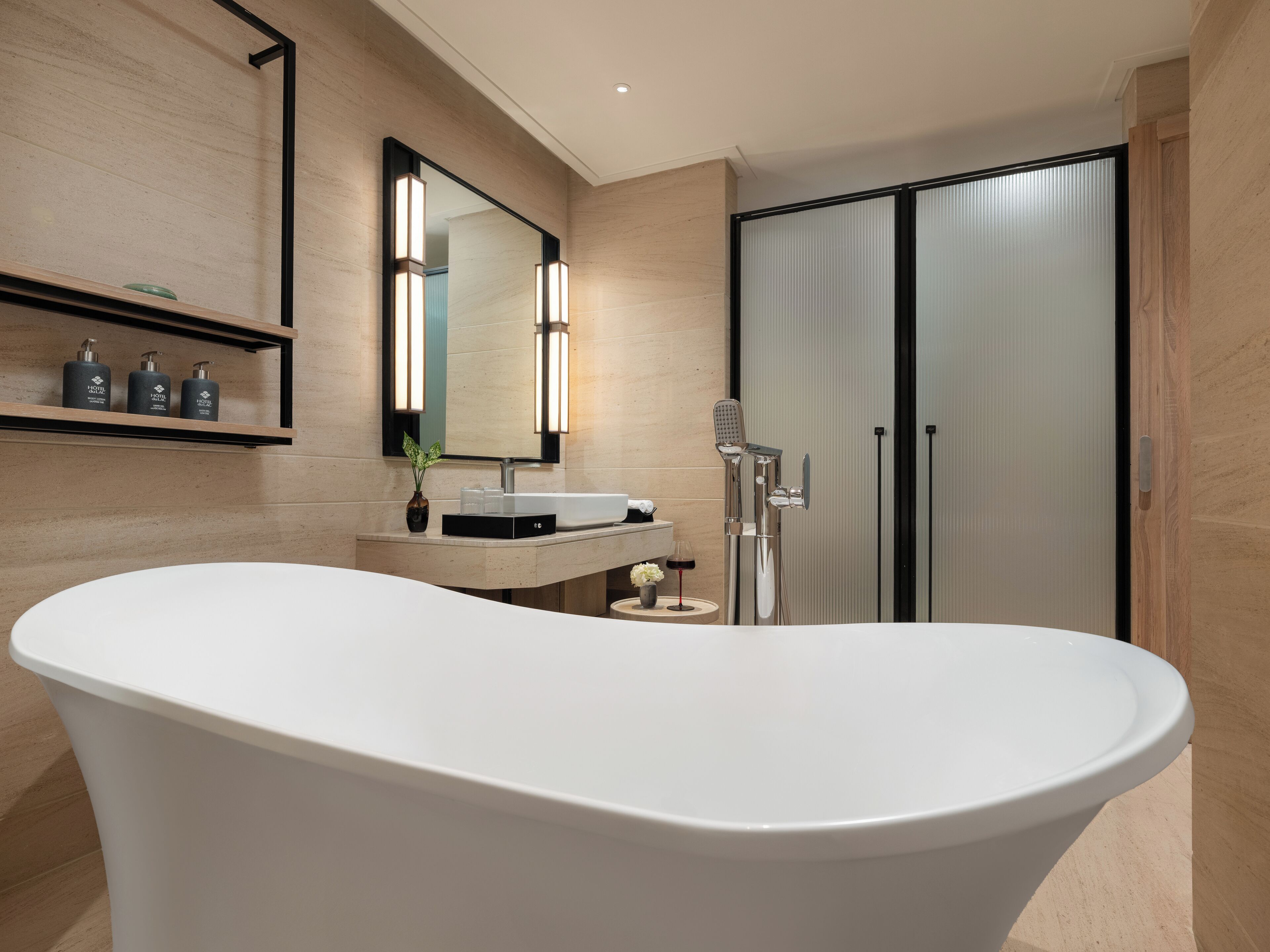 A modern bathroom with a freestanding bathtub, a vanity with a mirror, and a shower area.