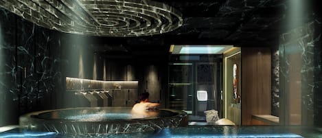 A spa area with a hot tub, marble walls, and a modern ceiling design.