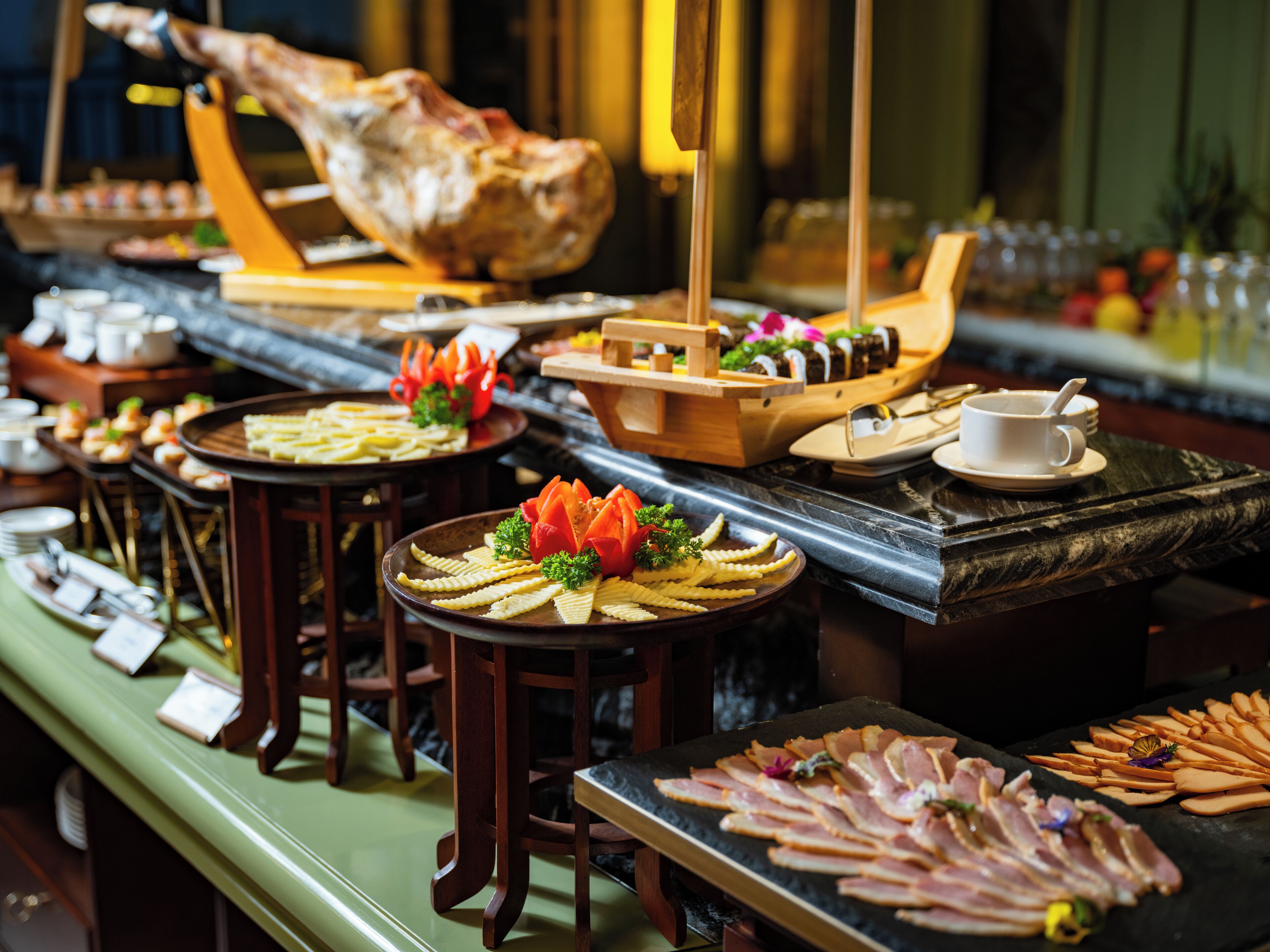 A buffet with various food items and a large roasted pig centerpiece.