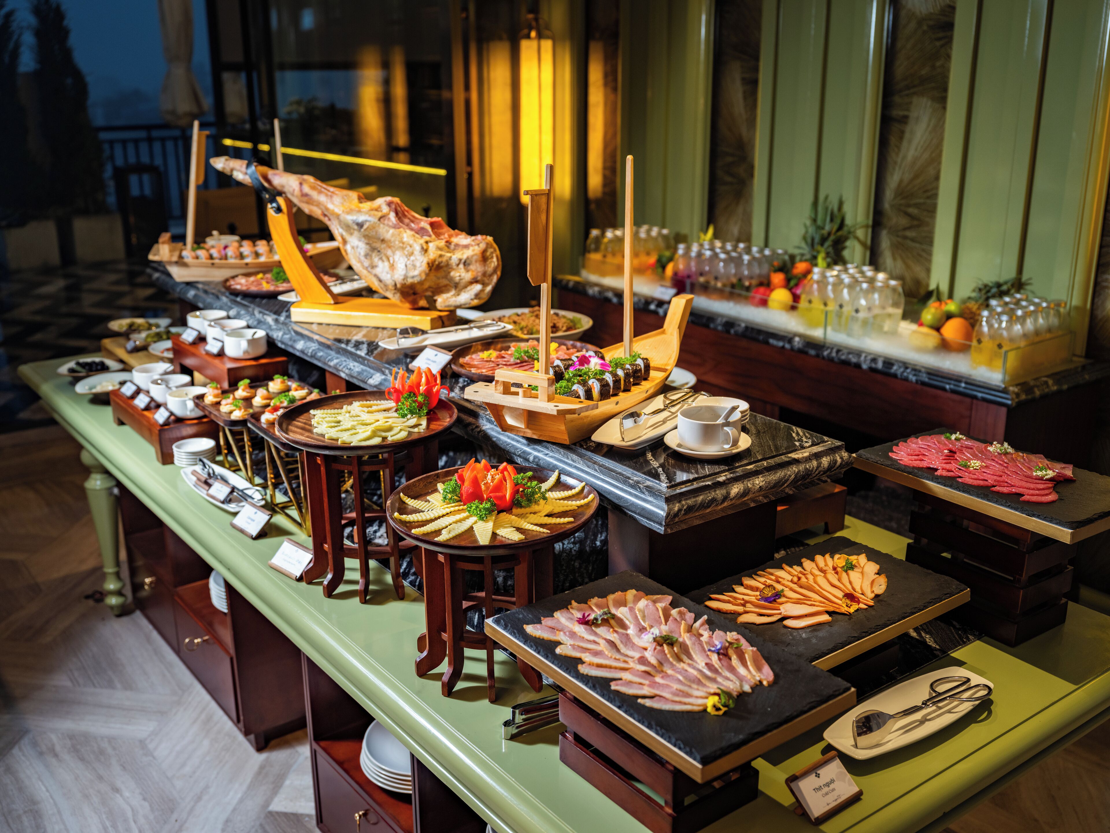 A buffet with various food items and utensils.
