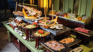 A buffet with various food items and utensils.