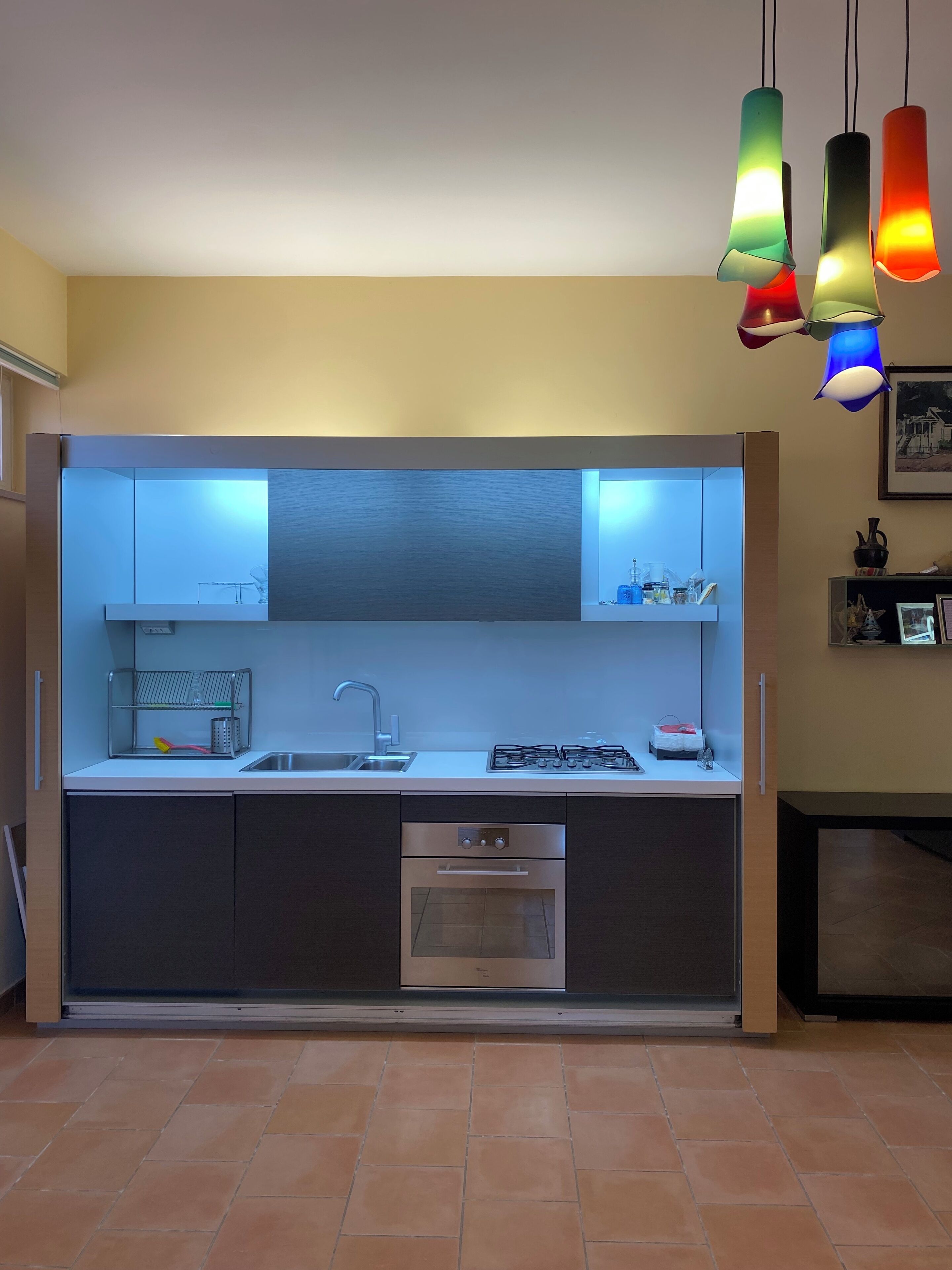 A modern kitchen with a built-in oven, a stainless steel sink, and a gas stove.