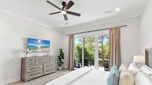 A bedroom with a bed, a dresser, a ceiling fan, and a view of the outdoors through a sliding door. - 6 Ensuite Bedrooms, Pool, Close to Beach, Luxury (Santa Rosa Beach)